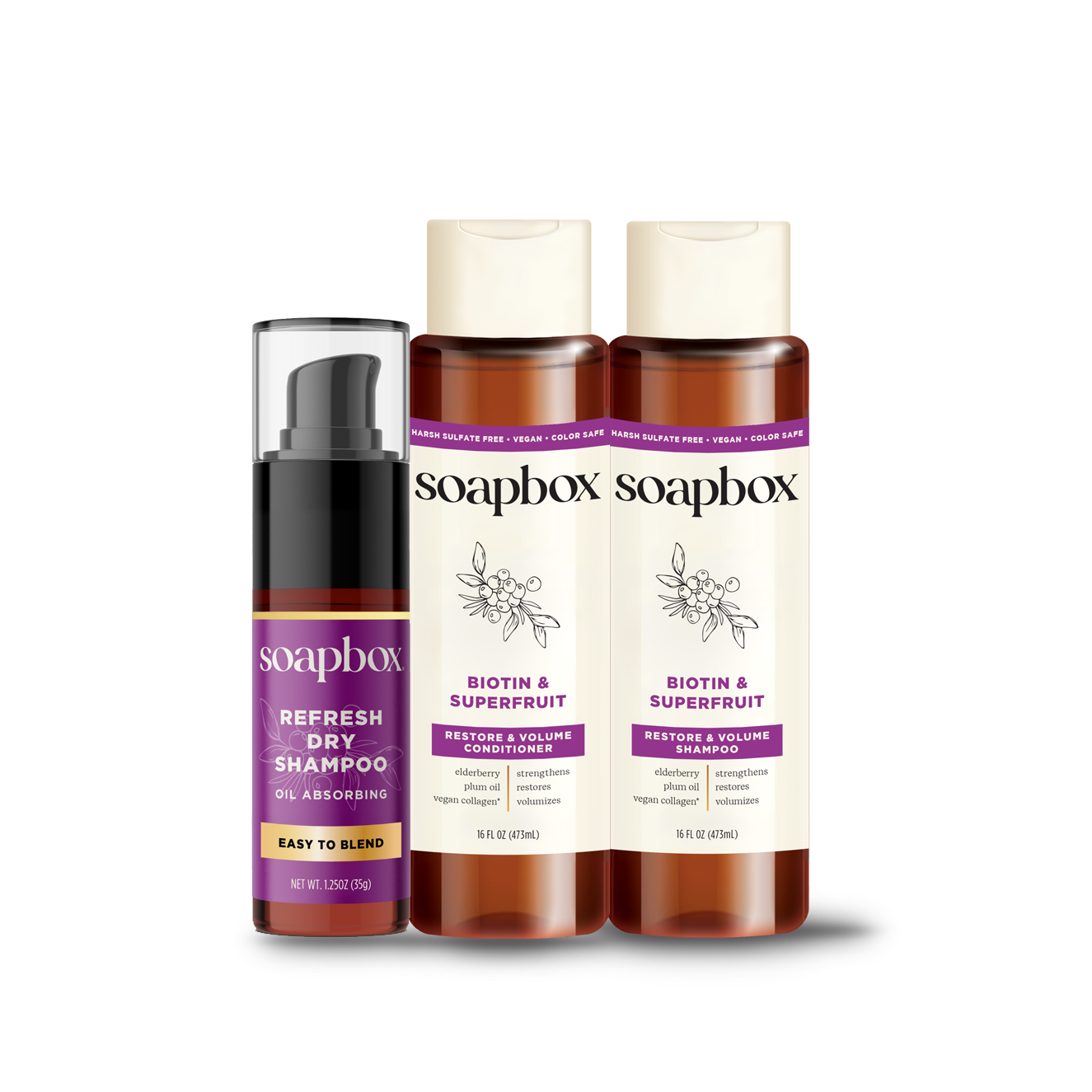 Three Soapbox haircare products: dry shampoo spray, shampoo, and conditioner in amber bottles with purple labels.