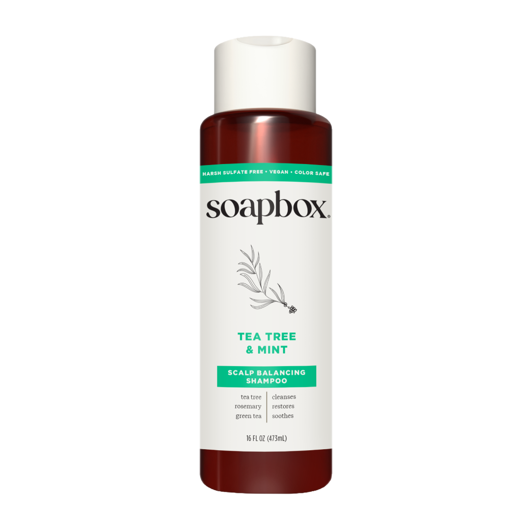Soapbox Tea Tree & Mint Scalp Balancing Shampoo bottle with white cap and dark red liquid, 16 fl oz.