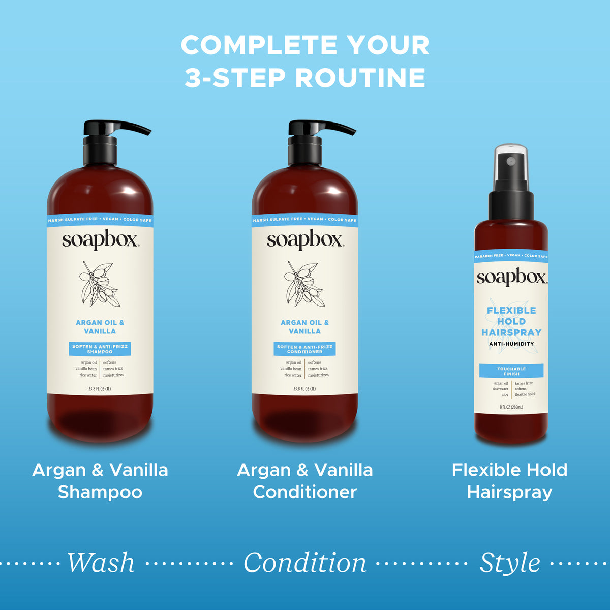 Two Soapbox pump bottles with argan oil and vanilla labels and one spray bottle of flexible hold hairspray on blue background