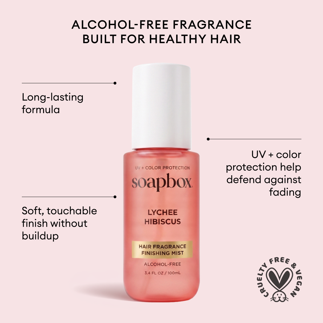 Coral-colored Soapbox Lychee Hibiscus Hair Fragrance Finishing Mist bottle with white cap on pink background.