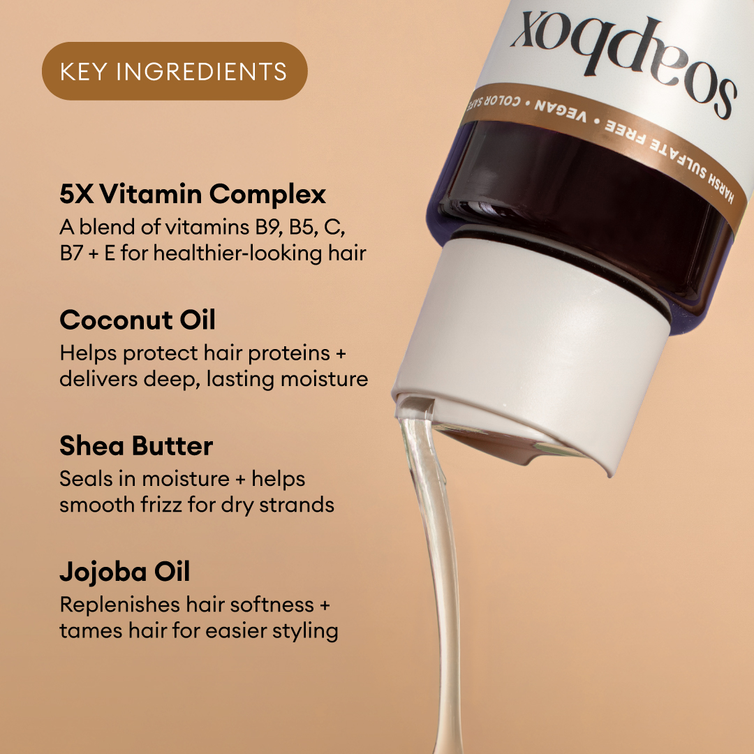 Dark bottle with white label and tan band listing key ingredients: vitamin complex, coconut oil, shea butter, and jojoba oil 