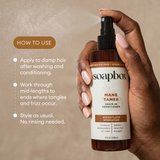 Hand holding Soapbox Mane Tamer leave-in conditioner spray bottle with brown and white label, 8 fl oz.
