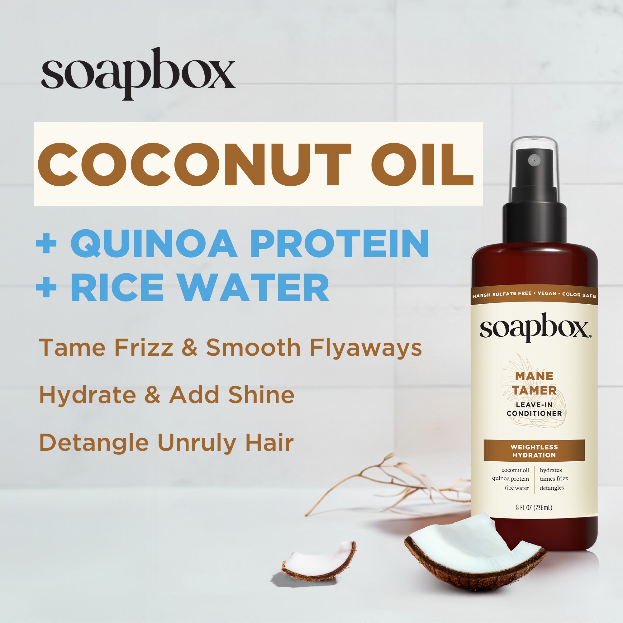 Soapbox Mane Tamer leave-in conditioner spray bottle with coconut oil and quinoa protein beside coconut halves.