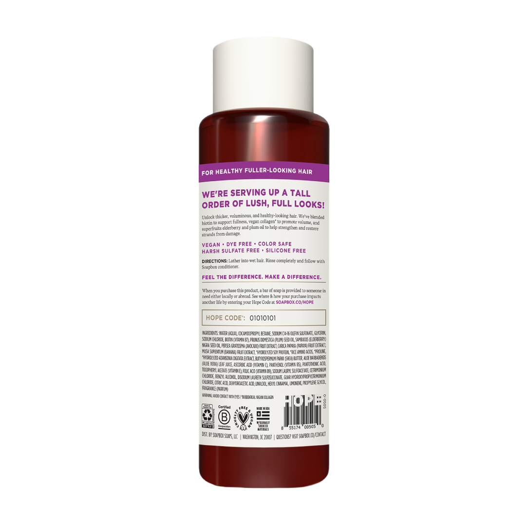 Cylindrical bottle with white cap containing dark red liquid shampoo, labeled with purple text and product information.