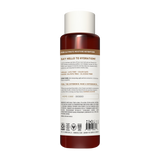 Cylindrical bottle with white cap containing dark red conditioner, labeled with product information and certification badges.