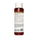 Cylindrical shampoo bottle with white cap and dark red liquid, featuring product information and ingredient list on label.