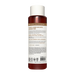 Cylindrical shampoo bottle with white cap and dark red liquid, featuring product information and ingredient list on label.