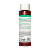 Bottle of dark red shampoo with white cap and green label band featuring product information and ingredient list.