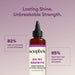 Soapbox "Oh My Growth" lengthening vitamin booster in amber bottle with black pump cap on mauve background.