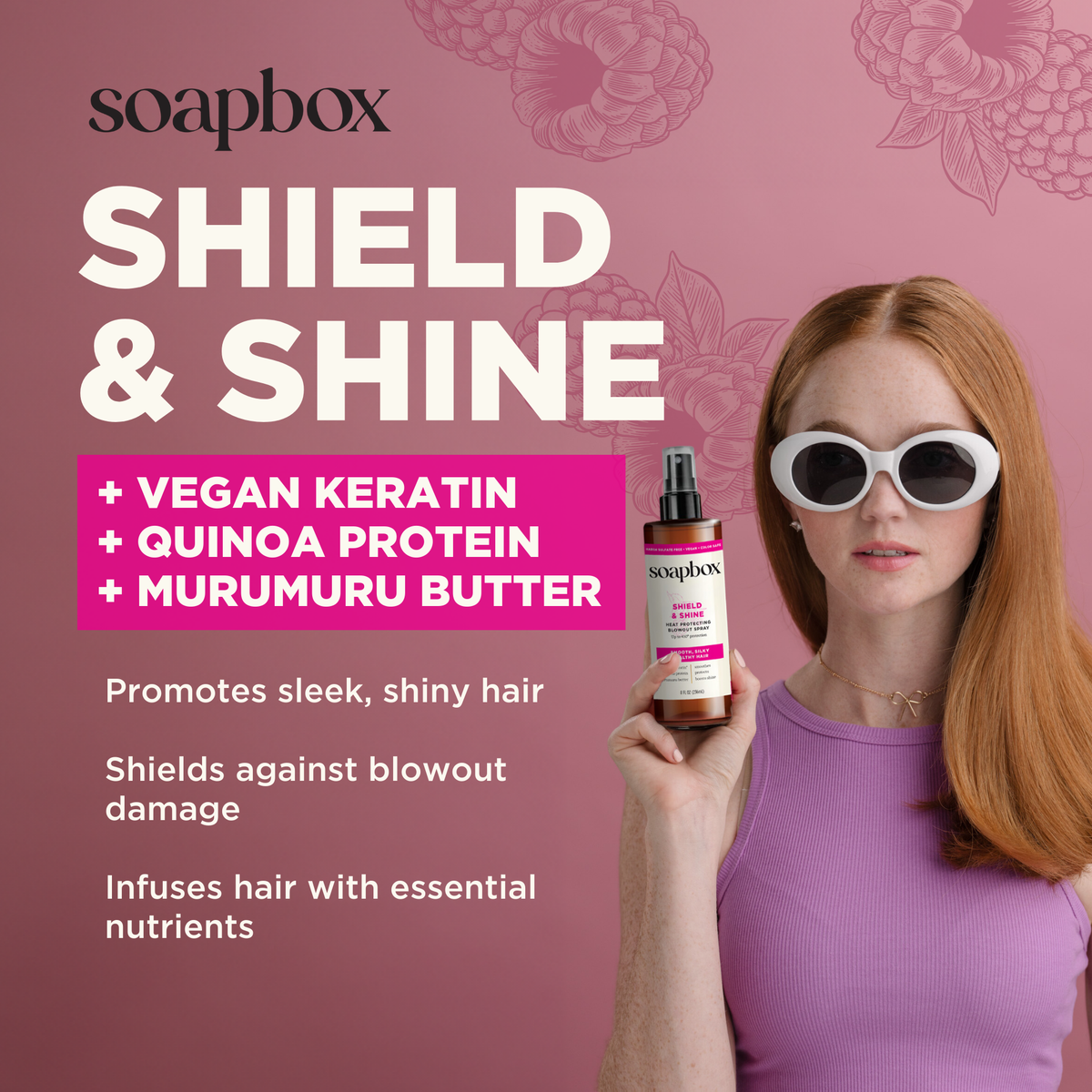 Soapbox Shield & Shine heat protecting spray bottle with pink label held by model with reddish-brown hair against mauve backg