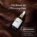 Hair serum bottle with text 'Hit Reset on Thinning Hair' and product details on a background of brown hair.