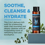 Soapbox scalp care 2-in-1 shampoo and conditioner bottle with black cap on gray cube surrounded by eucalyptus sprigs.