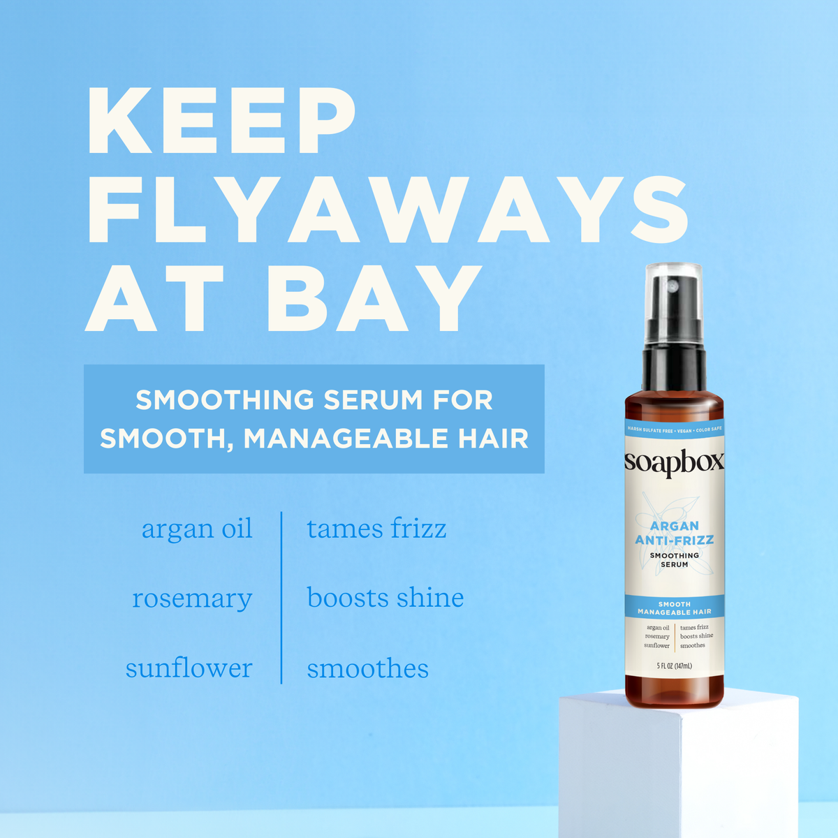 Clear glass bottle with spray nozzle containing amber-colored serum labeled "Argan Anti-Frizz Smoothing Serum" by Soapbox on 