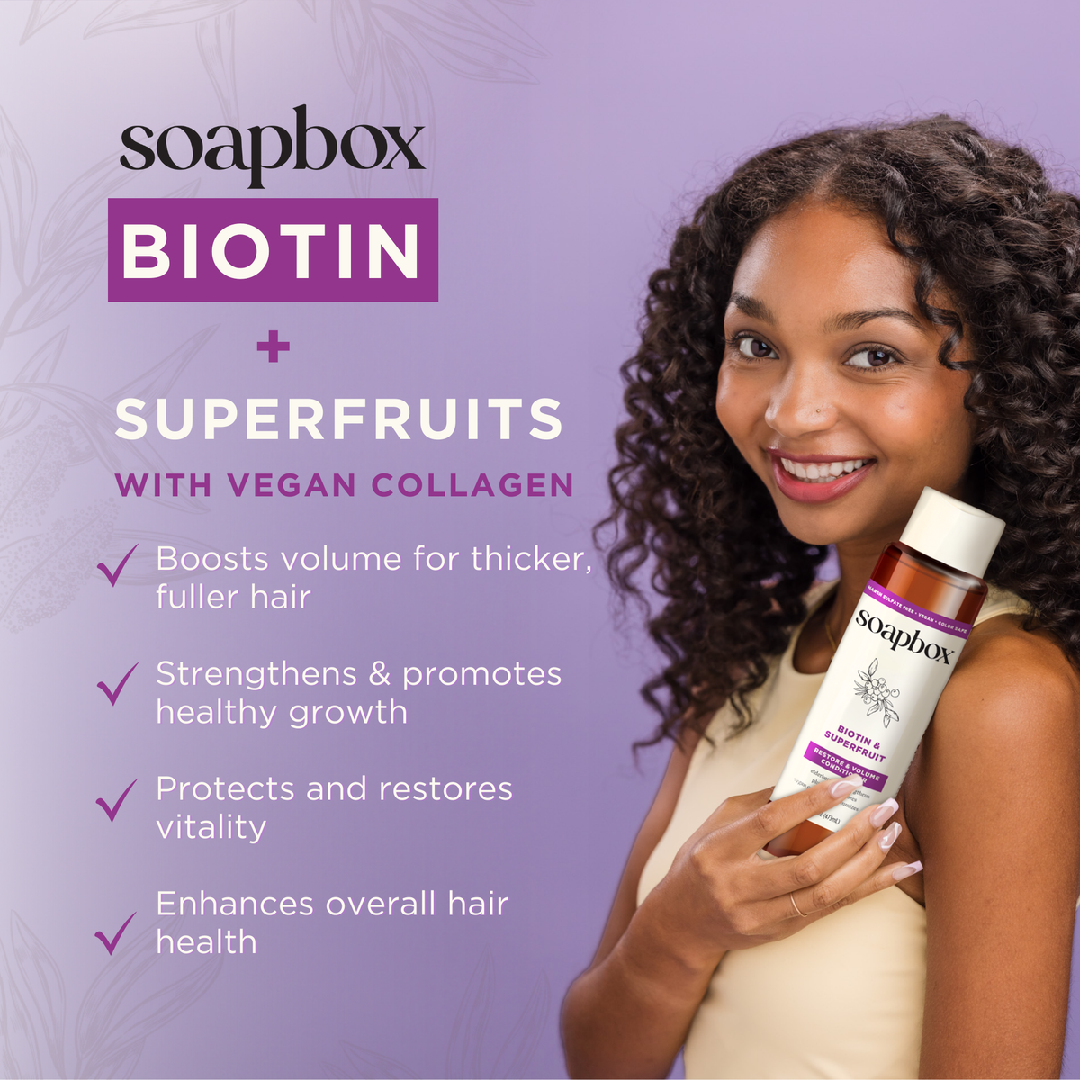 Soapbox Biotin and Superfruits shampoo bottle held by woman with curly dark hair against purple background.