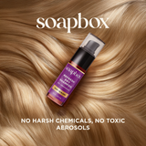 Soapbox Refresh dry shampoo spray bottle with purple label on blonde hair background.