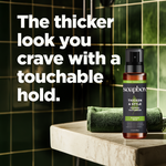 Soapbox Thicken & Style Foaming Texturizer spray bottle with amber glass and black pump top on marble surface.