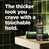 Soapbox Thicken & Style Foaming Texturizer spray bottle with amber glass and black pump top on marble surface.