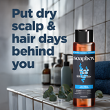 Soapbox Scalp Care 2-in-1 Shampoo and Conditioner bottle with tea tree and eucalyptus, displayed with towel and botanicals.