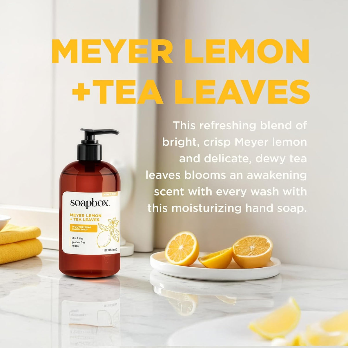 Amber pump bottle of hand soap with label, displayed on marble counter with sliced meyer lemons and yellow towel.