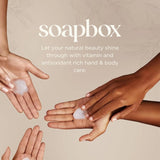 Multiple hands with different skin tones applying white liquid soap with "soapbox" branding and tagline visible.