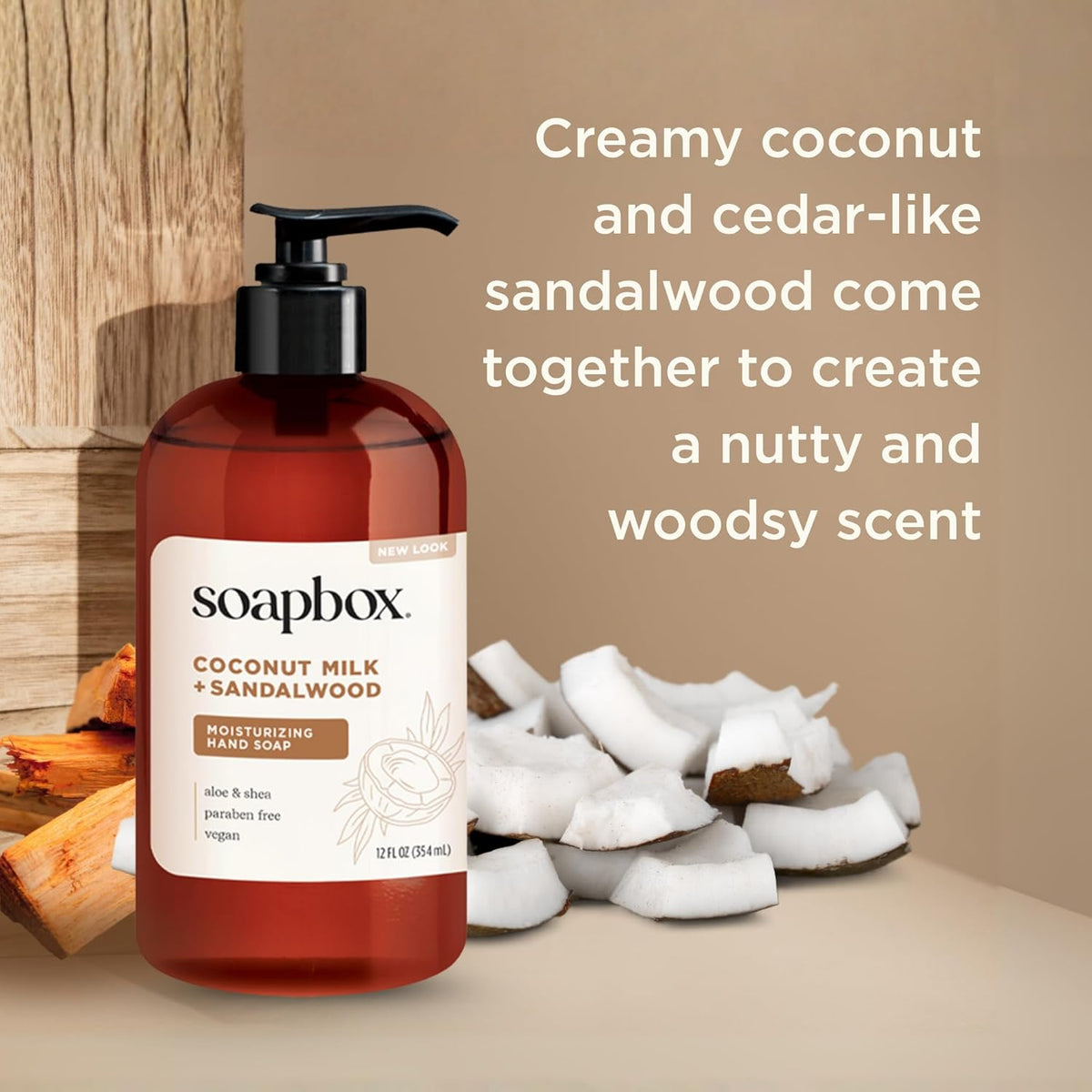 Red pump bottle of Soapbox coconut milk and sandalwood hand soap with coconut pieces and wood elements on beige background.
