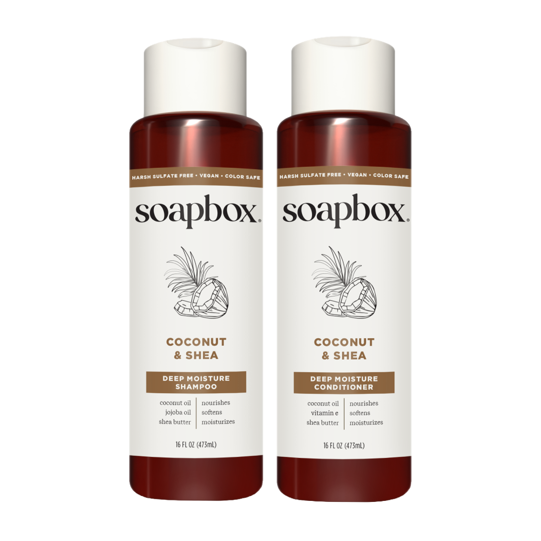 Two Soapbox bottles with white caps and dark red lower sections labeled Coconut & Shea Deep Moisture Shampoo and Conditioner,