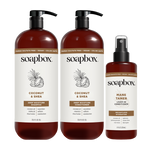 Three Soapbox haircare bottles: two large pump bottles of Coconut & Shea Deep Moisture Shampoo and Conditioner, and one spray
