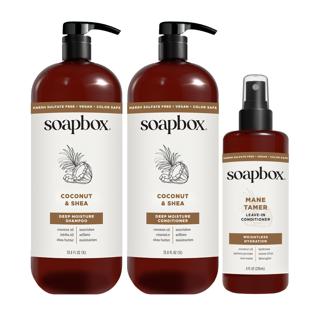 Three Soapbox haircare bottles: two large pump bottles of Coconut & Shea Deep Moisture Shampoo and Conditioner, and one spray