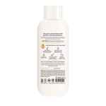 Cream-colored body wash bottle with white cap and text describing hydrating formula with oat butter and hyaluronic acid.