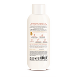 Cream-colored body wash bottle with white cap and product information label on front.