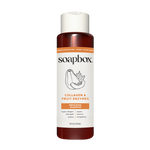 Soapbox bottle with white cap containing amber-colored liquid, labeled "Collagen & Fruit Enzymes Repairing Shampoo" with frui