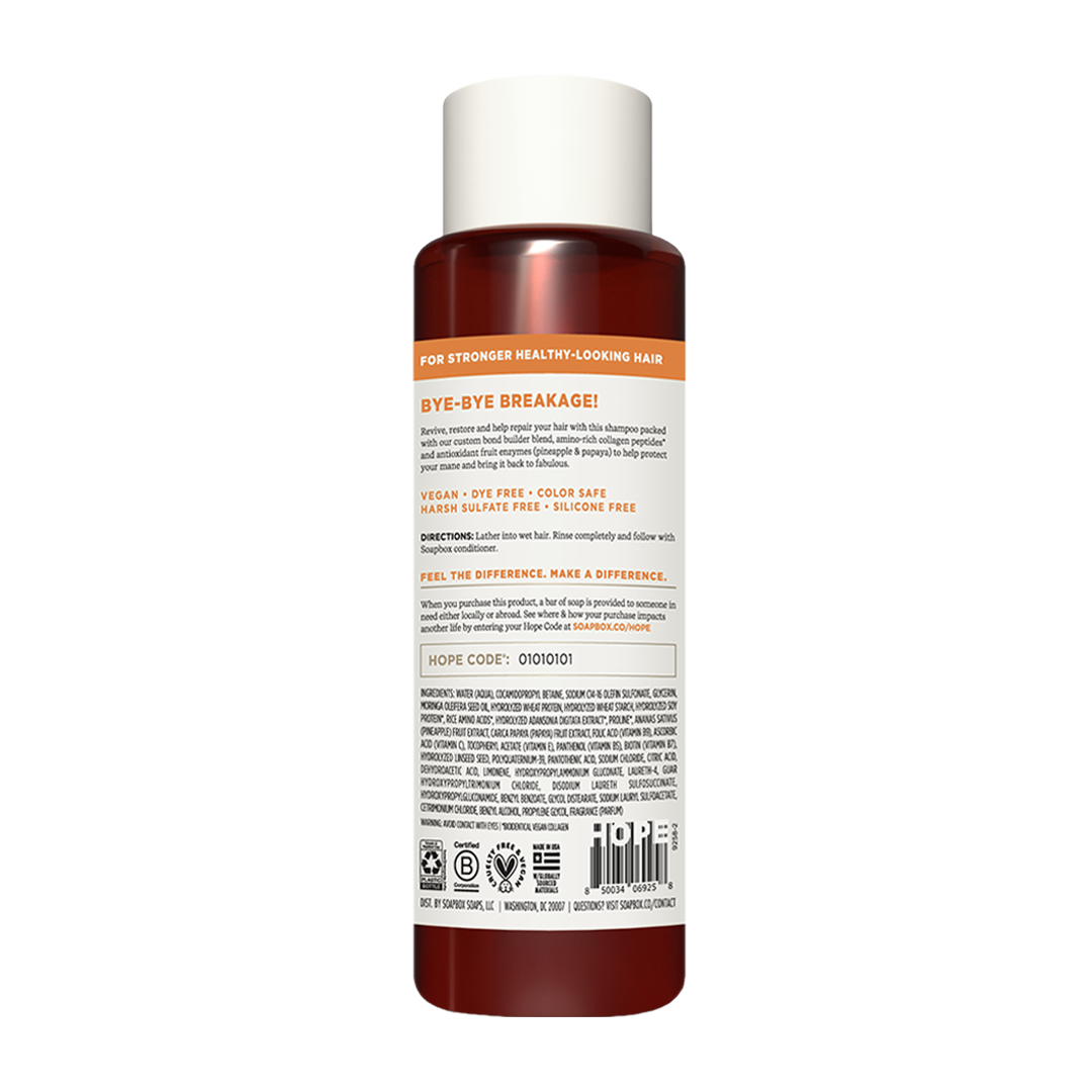 Dark amber bottle with white cap containing repairing shampoo, labeled with product information and certifications.