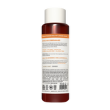 Dark amber bottle with white cap containing repairing shampoo, labeled with product information and certifications.