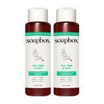 Two Soapbox bottles with white caps and dark red lower sections labeled tea tree & mint scalp balancing shampoo and condition