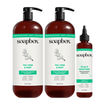 Three Soapbox Tea Tree & Mint scalp care products: two large pump bottles of shampoo and conditioner, and one smaller dropper