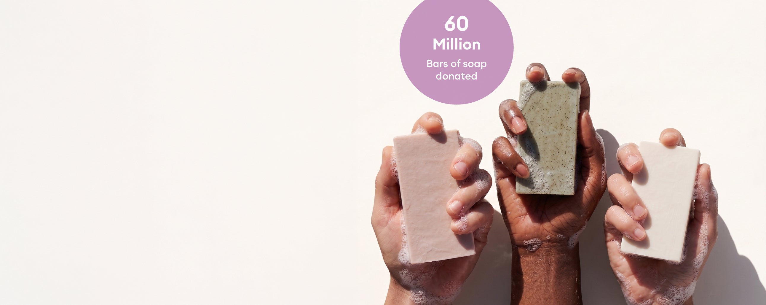 Hands holding Soapbox bars of soap