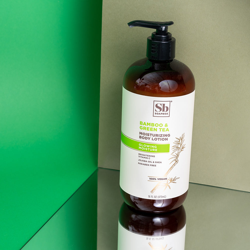 Dark amber bottle with black pump dispenser containing Bamboo & Green Tea body lotion by Soapbox, 15 fl oz.