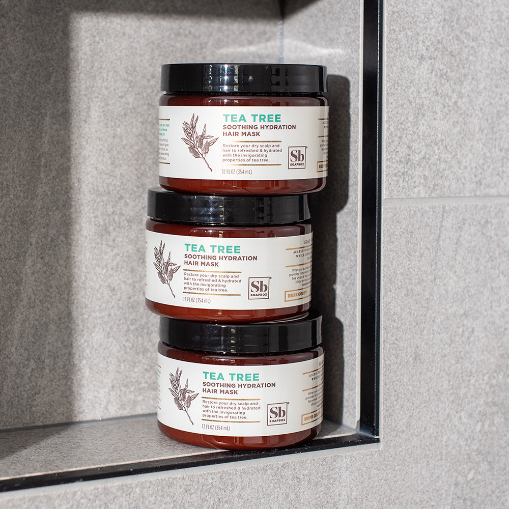 Three stacked jars of Tea Tree Soothing Hydration Hair Mask with amber glass containers and black lids.