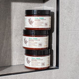 Three stacked jars of Tea Tree Soothing Hydration Hair Mask with amber glass containers and black lids.