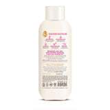 Cream-colored bottle of nourishing body wash with white cap and pink ingredient icons on label.